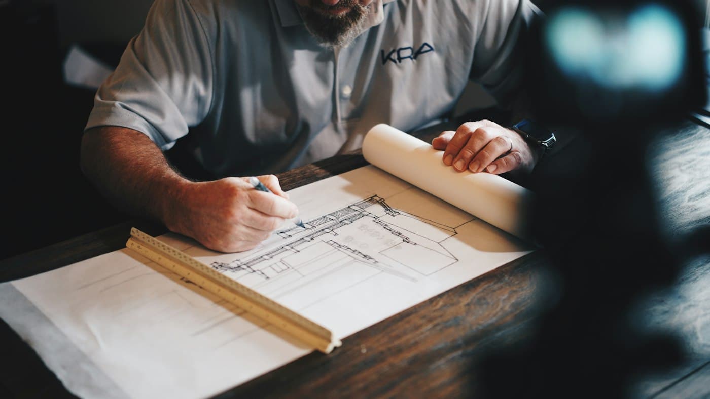 Engineer working on technical drawings